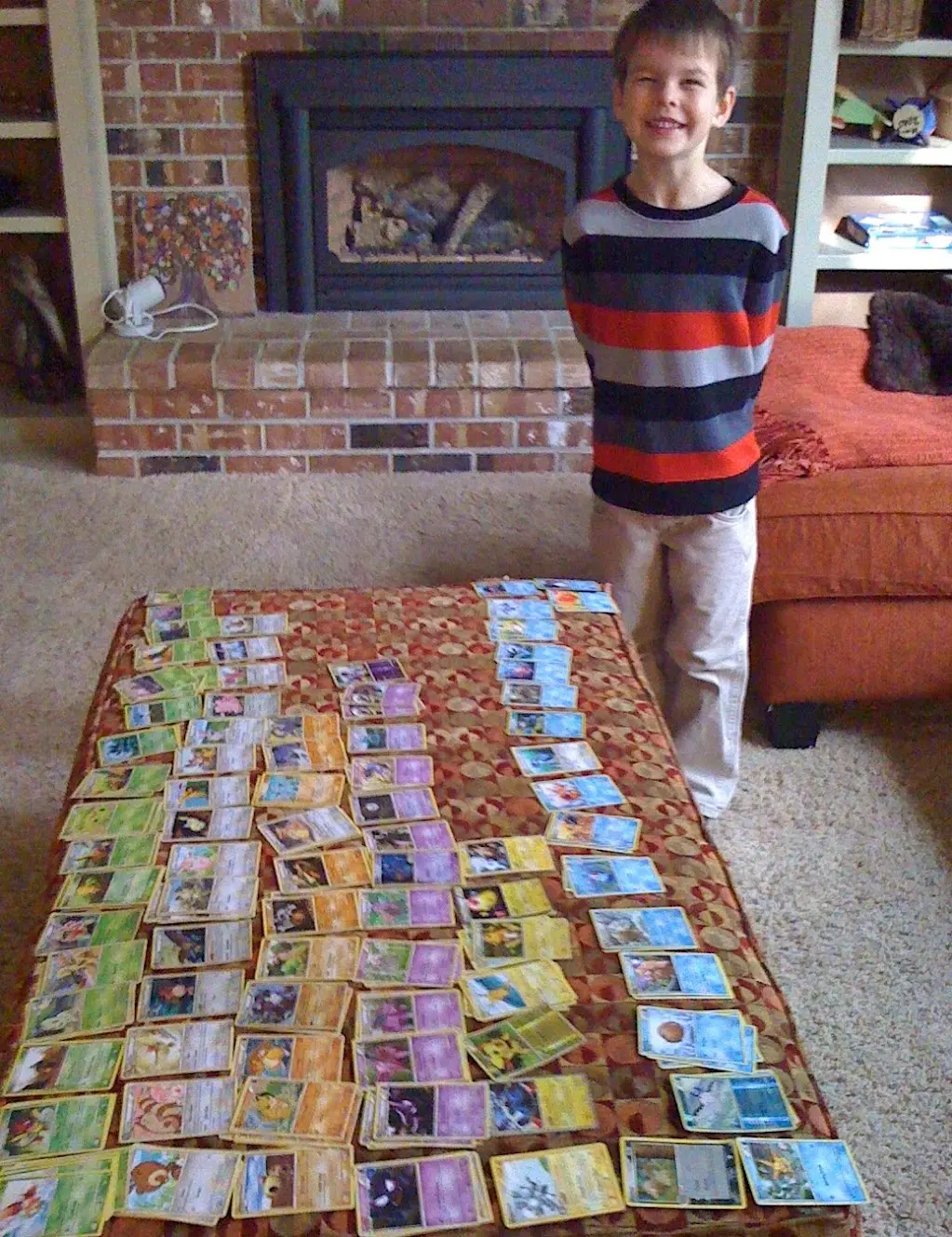 A childhood Pokémon card collection spread out on the floor